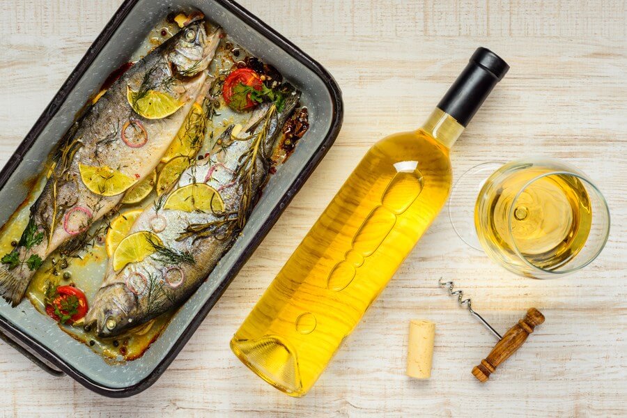 Beautiful cooked fish along white wine varieties
