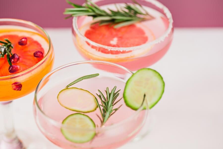 An amazing picture of 2 beautiful Rosé cocktails, with amazing garnishes!