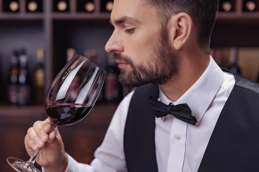 Wine Palate - A Sommelier smelling a beautiful vintage of red wine, ready to describe it's wonderful features!