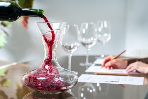 A beautiful red wine being poured into an amazing wine decanter, a great idea for a wine-related gifts